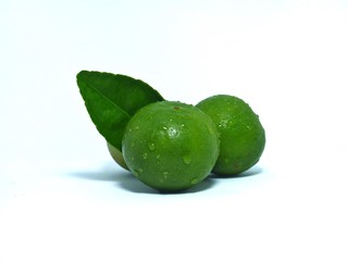 limes on a plate isolated on white background