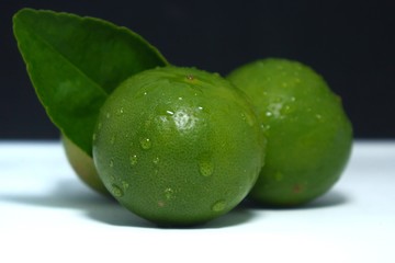 fresh limes on black background