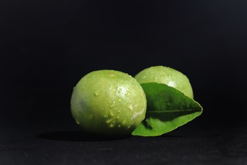 fresh limes on black background