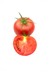fresh tomato and half a tomato with dew drops isolated on white background