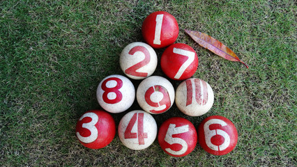 Balls in the field. People, men and women, play gateball game in a field in the morning to exercise and improve friendship after retirement, a fast-paced, non-contact, highly strategic team game.