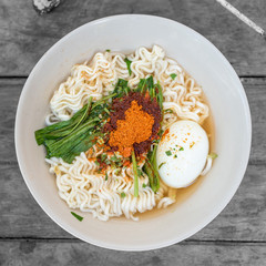 Top view Thai noodles with flavouring powder and vegetable.