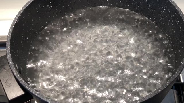 Water boiling in a pot.