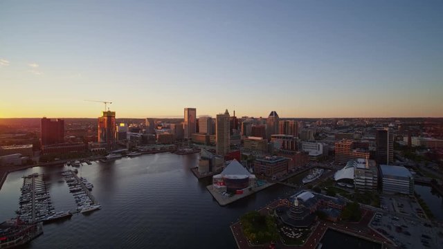 Baltimore Maryland Aerial v39 Flying toward downtown over harbor with picturesque cityscape views to panning into sunset - October 2017
