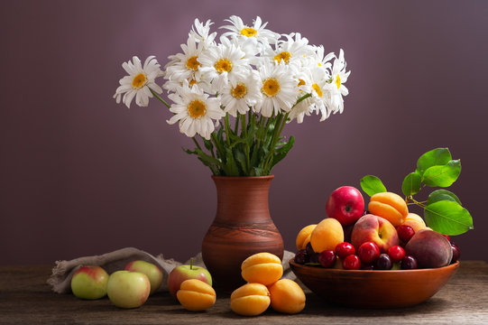 Still Life With Bouquet Of Daisy Flowers In A Jar And Fresh Fruits