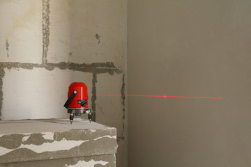 Laser level measuring tool in construction site.