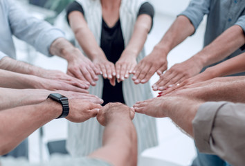 Fototapeta premium close up.young business team forming a circle of hands