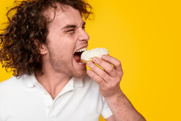 Hungry man eating donut