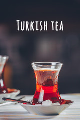 Turkish tea in the restaurant. Turkish cuisine and travel concept. Vertical. Turkish tea wording
