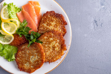 Tasty potato pancakes with caviar and salmon. Top view. Space for text