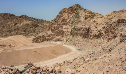 quarry desert scenery landscape place with sand stone rocks and trail on a ground in empty...