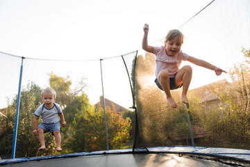 Kids jumping high on trampoline