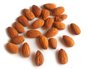 Raw peeled almond grains isolated on white background. Top view.
