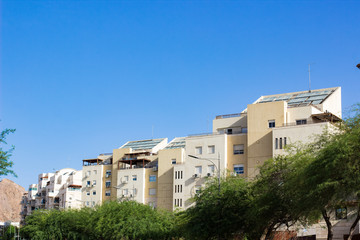 Obraz premium suburban European city street living houses with green tree and clear summer weather time 