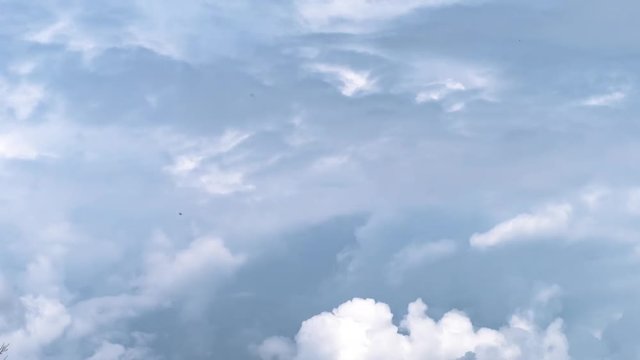 Time lapse clouds, grey clouds motion in horizon, blue fluffy, puffy cloud, nice blue sky. Time lapse move cloud background Blue cloudscape skies fast motion, rolling.