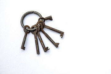 Bunch of different keys on a white background. New housing, property and mortgage loan concept. Copy space