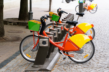 Electric bike rental station in urban setting.