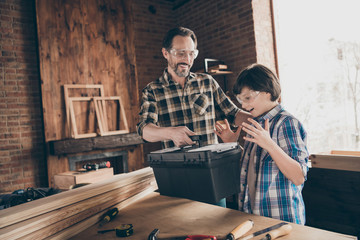 Portrait of two nice person cheerful cheery glad successful woodworkers master handyman dad giving...