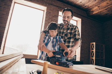 Low angle view of two nice smart clever creative cheerful person master builder dad fixing creating repairing building cabinetry restoration at modern studio loft industrial brick interior indoors