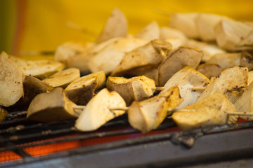 Grilled king oyster mushroom selling on night market., Thailand famous street food.