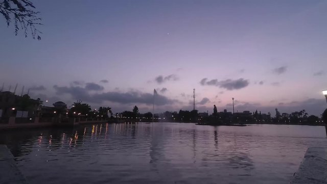 Evening to night time lapse of lakeside with clouds and reflection it in water