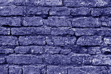 Old grungy brick wall texture in blue tone.