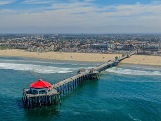 Aerial view of Huntington Pier, beach & coastline during sunny summer day, Southeast of Los...