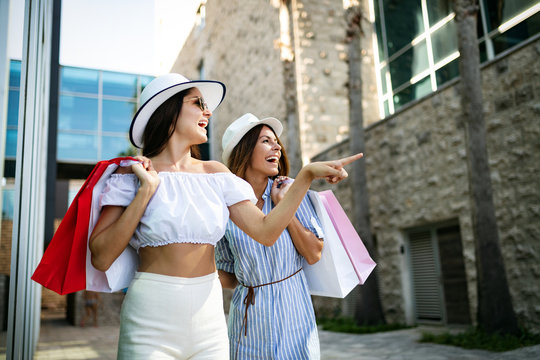 Happy friends shopping and traveling at summer