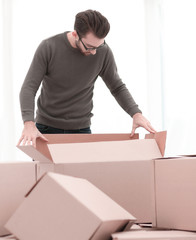 confident man unpacking boxes in the new house