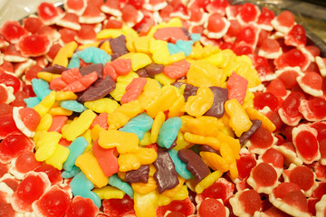 delicious multi-colored fruit marmalade. unhealthy bright candies in bulk. different jelly photo close. tasty sweets in the candy shop. nobody. 