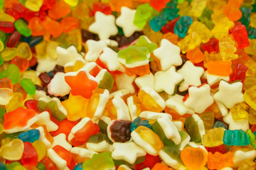 delicious multi-colored fruit marmalade. unhealthy bright candies in bulk. different jelly photo close. tasty sweets in the candy shop. nobody. 