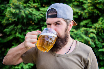 Enjoying his alcoholic beer. Bearded man drinking alcoholic drink in summer. Hipster with alcoholic...