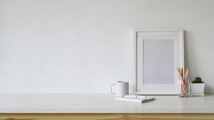White workspace empty poster and copy space with home office supplies.