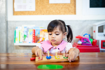 child little girl playing wooden toys