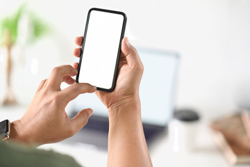 Businessman's hand using blank white screen mobile smart phone.