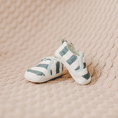 Newborn boots. Baby booties on knitted fabric. Baby boy shower concept. copy space, top view 