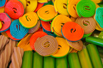 delicious multi-colored fruit marmalade. unhealthy bright candies in bulk. different jelly photo close. tasty sweets in the candy shop. nobody. 