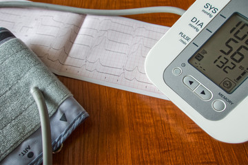 Blood pressure monitor, blood pressure monitor cuff, cardiogram printout.