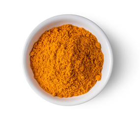 Turmeric powder in ceramic bowl  isolated on white background. top view