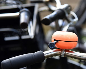 Orange Klingel in einem Meer geparkter Fahrräder