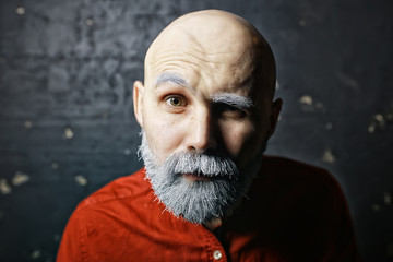Obraz premium Santa Claus hipster / portrait of a fashionable modern Santa, young man with a gray beard, Christmas winter portrait