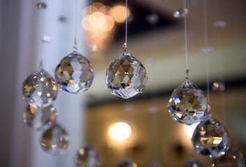 Glass faceted hanging balls. The subject of interior decoration and space in the room. 