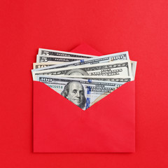 American dollars in cash in red envelope on minimal style bright background. Money mail, finance...