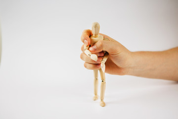 Manipulation of wooden puppet.Puppeteer. The hand controls the puppet strings. Manipulation of the ...