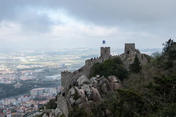 Obraz premium The Castle of the Moors, a hilltop medieval castle located in Sintra, Portugal, built by the moors and was an important strategic point during the Reconquista