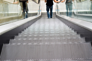 A man downing the escalator in shopping mall