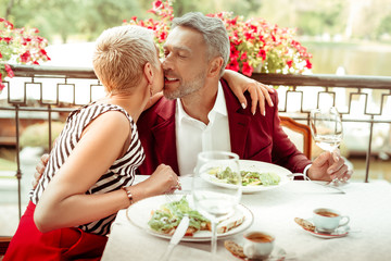 Loving thankful wife hugging and kissing her handsome husband