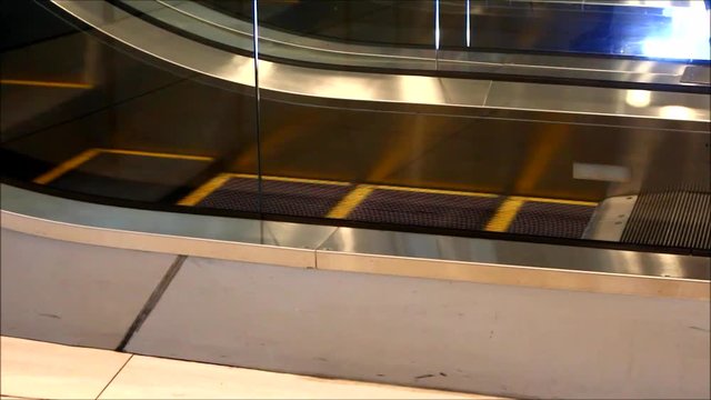 Handheld video shot of an escalator in a commercial building