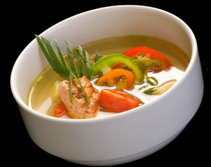 A white bowl with fish soup, Close up.