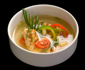 A white bowl with fish soup, Close up.